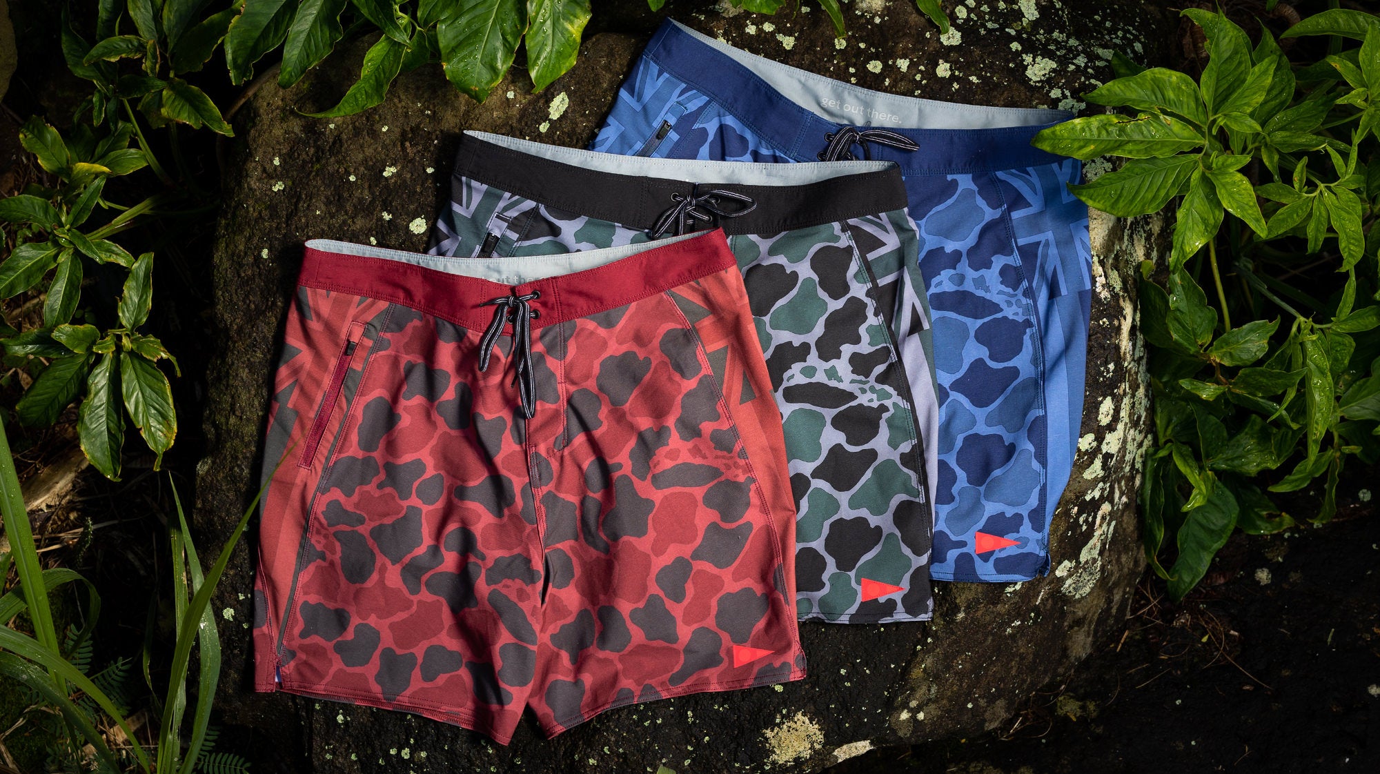 Pro Hawaii Camo Boardshorts in Maroon, Dark Emerald in Navy ona. lava rock in Hawaii. 